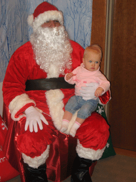 Sitting on Santa's lap at Daddy's work