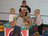 Kaitlyn, Ryan, and Alexander playing with the trains