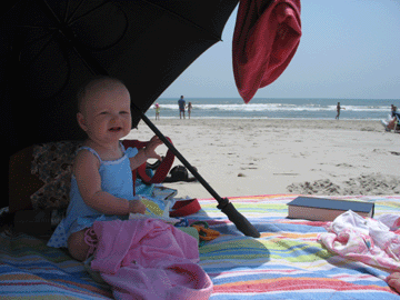 Playing in the shade under the umbrella