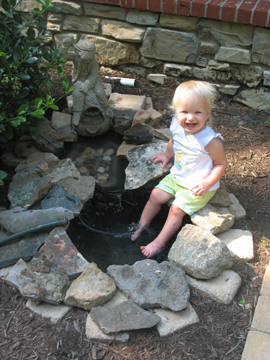 Dipping her feet in the fountain