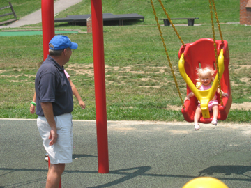 Loving getting pushed in the swing by Uncle Rick