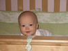 Peeking over her crib